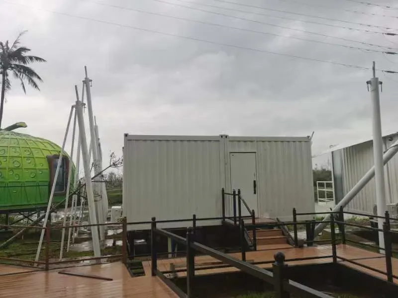 Container building and dome unit intact on the same site after a typhoon passed through a coastal landfall zone