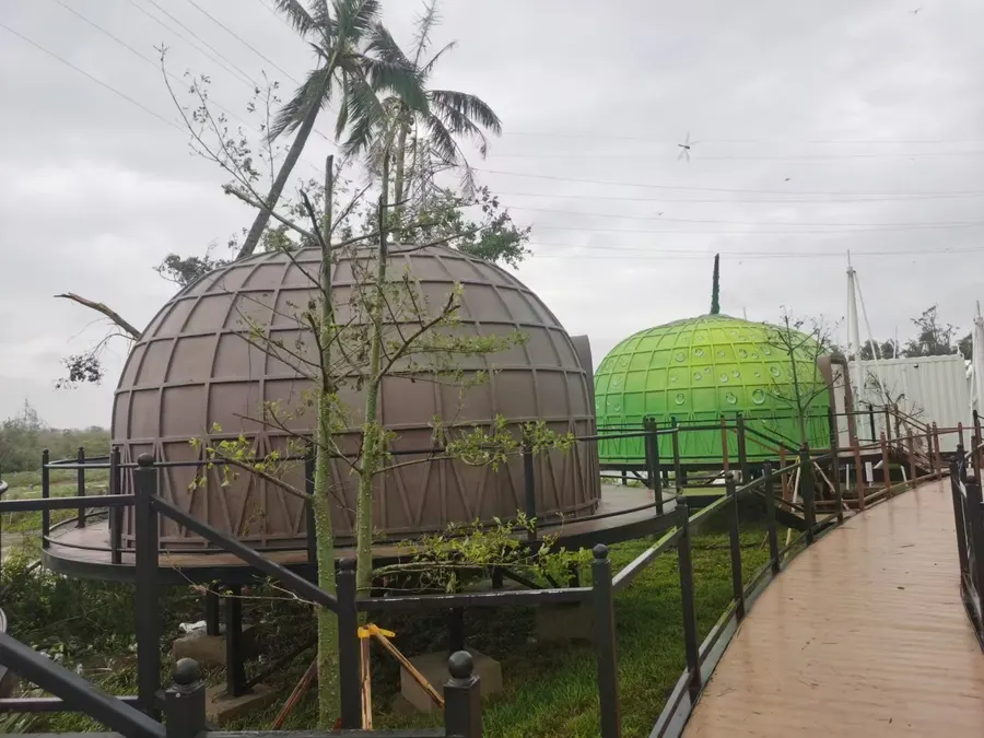 Two dome units intact on steel platforms after a typhoon passed through a coastal landfall zone